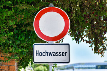 Water flood sign at German Rhine river saying 'Hochwasser', meaning 'water flood'