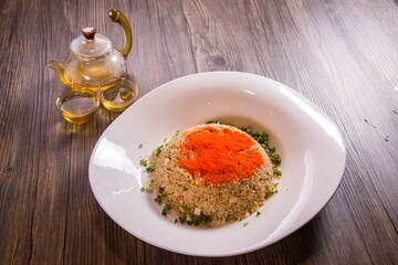 japanese wok egg fried rice with seafood fish roe in thick sauce gravy in plate on wood background asian cafe cuisine Chinese restaurant banquet halal food menu
