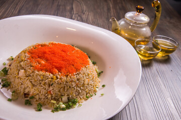 japanese wok egg fried rice with seafood fish roe in thick sauce gravy on wood background asian halal banquet menu