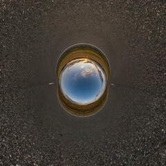 blue sphere little planet inside gravel road or field background.