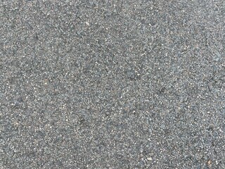 Fine details of a tarmac road surface.