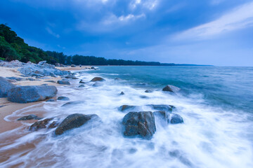 Seascape view of a tropical beach at dusk.