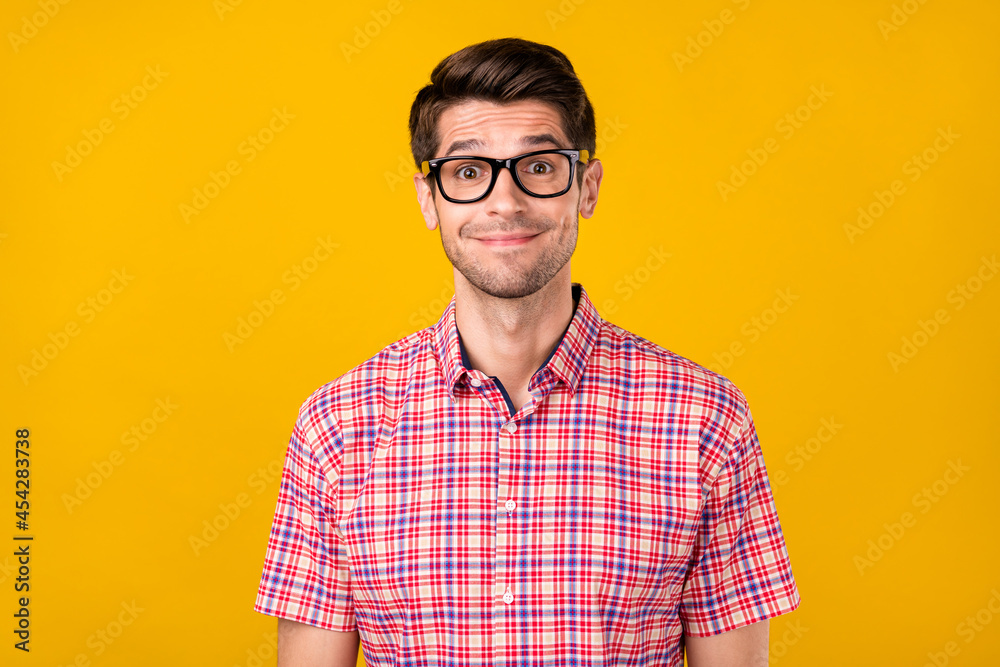 Poster portrait of attractive cheerful funny guy geek it specialist wearing specs isolated over vibrant yel