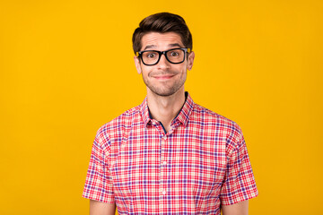 Portrait of attractive cheerful funny guy geek it specialist wearing specs isolated over vibrant...