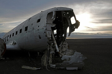 Abandoned plane wreck at Solheimasandur, Iceland, in the evening with a dramatic sky in the background