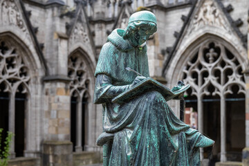Obraz premium Statue of the writing lawyer, Hugo Wstinc (1916) part of a fountain in the Pandhof in Utrecht, Utrecht Province, The Netherlands