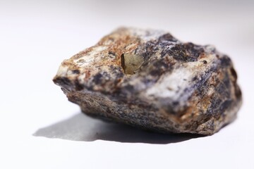 Macro of pyrite crystal (fools gold) in a rock, isolated on white