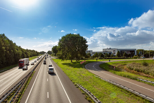 Cars and trucks driving on the A44 highway near the South-Holland village of Sassenheim in the township Teylingen in the Netherlands. At the Exit Hotel Sassenheim.