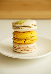 Macaroons on white plate. French cuisine dessert. Gentle colors