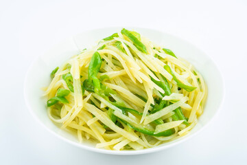 Shredded potatoes with green pepper on a saucer on white background