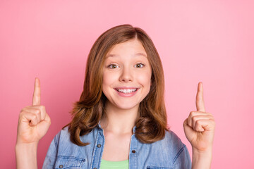 Photo of young attractive girl happy positive smile point fingers empty space ad choice isolated over pink color background