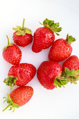 ripe fresh strawberries on a white background. Natural ripe strawberries, strawberries of different sizes are laid out on a white background in a circle