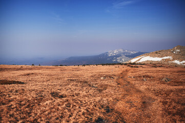 Fototapeta na wymiar Rocky mountain peaks at the horizon