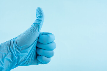 Doctor wearing blue gloves thumb up gesture