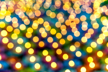 Golden circular blur light bokeh abstract on a blurred blue background. Holiday concept backdrop with twinkling bright shapes.Blinking Christmas