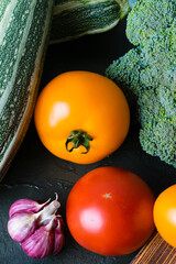 Healthy nutrition concept. Lots of vegetables on a dark table top, view from the top