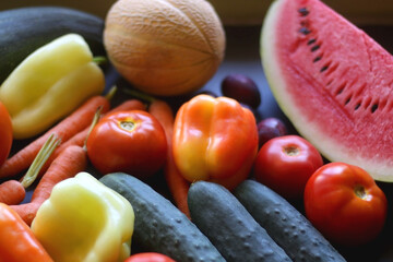 Various colorful summer fruit and vegetable on dark background. Selective focus.