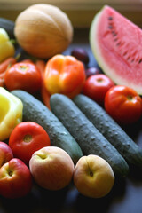 Various colorful summer fruit and vegetable on dark background. Selective focus.