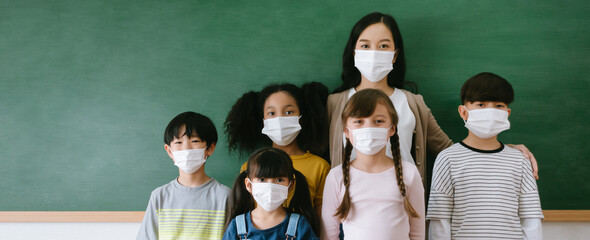Multiethnic group of kids with their teacher wearing face mask, self-protection from corona virus...