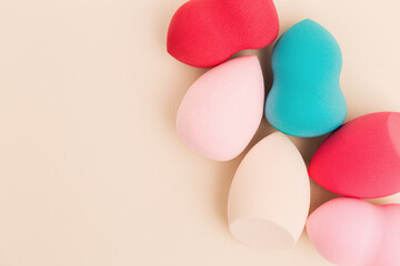 Color cosmetic beauty blender sponges on beige background Professional sponges different shape