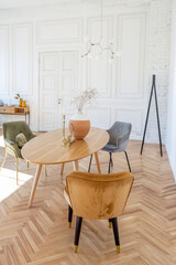 expensive modern light luxury interior design of a spacious living room with wooden elements and white walls. filled with original and unusual decorative things