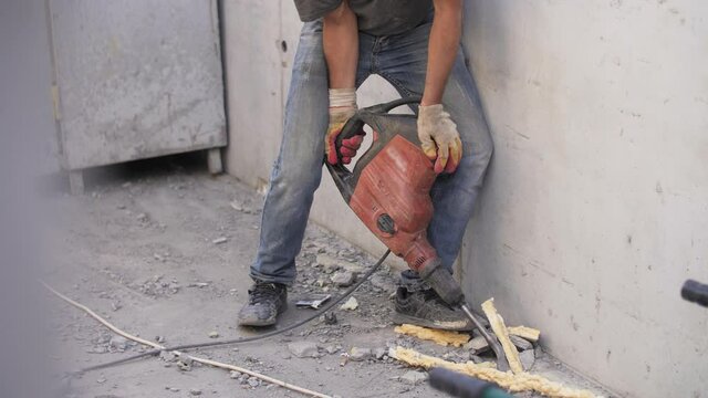 a construction worker uses a jackhammer