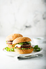Traditional homemade beef burgers with pesto sauce