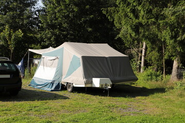 an old folding caravan on a campsite 