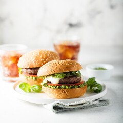 Traditional homemade beef burgers with pesto sauce