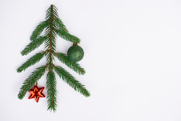 christmas tree with green  ball and red star on white backgrounds with free copy space, top view