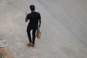 Kanpur, Uttar Pradesh India- August 25 2021: A tech-savvy adult person is using his smartphone...