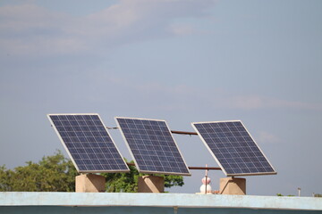 Three Solar panels consisting of photovoltaic cells are placed on the terrace for generating green energy.