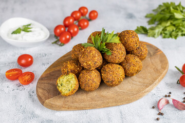 Falafel, a traditional Middle Eastern dish made from chickpeas with tzatziki sauce. Vegetarian food. Great snack