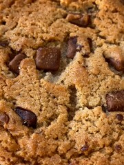 Cookie with chocolate pieces background