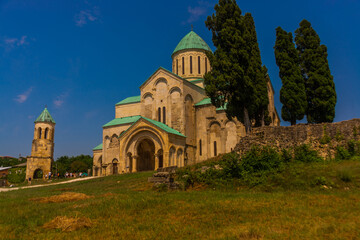 Fototapeta na wymiar KUTAISI, GEORGIA: Landscape with a view of the old Orthodox Cathedral of Bagrati on a sunny summer day.