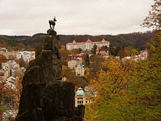 Famous chamois statue, symbol of Karlovy Vary spa town in autumn atmosphere with yellow coloured trees, Karlovy Vary, Czech Republic © Milan
