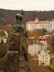Karlovy Vary famous chamois statue, symbol of spa town in autumn atmosphere above historic spa buildings and hotels, Karlovy Vary, Czech Republic © Milan