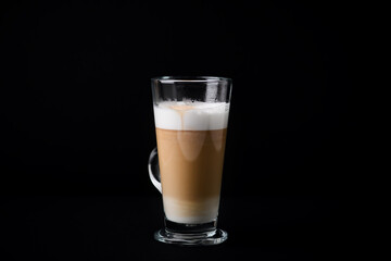 Coffee with milk on dark background. Close up. Copy space. 