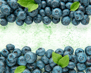 Blueberries on a green wooden background