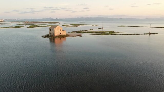 House isolated by water in mediterranean sea drone view. Lonely house in island surrounded by water as a consecuence of sea level growth due to melt down of polar ice, defrostation. 