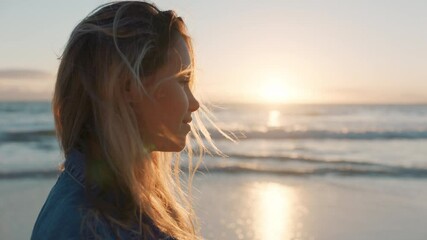 beautiful woman on beach looking at sunset on ocean horizon thinking of journey contemplating life enjoying peaceful summer vacation freedom