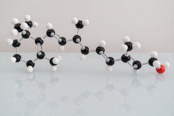 Isolated vitamin A made by molecular model with reflection on white background. Retinol chemical...