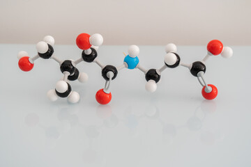 Isolated vitamin B5 made by molecular model with reflection on white background. Pantothenic acid chemical formula with atoms and bonds