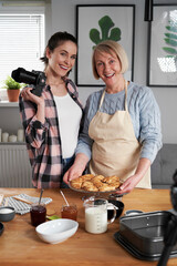 Vertical portrait of two generation vloggers