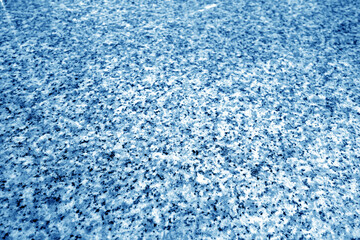 Granite surface as background with blur effect in navy blue tone.