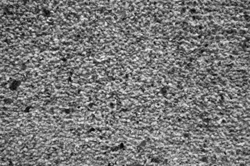 Wall covered with small stones in black and white.