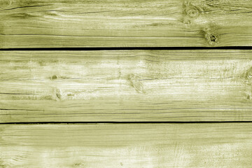 Wall made of uncutted weathered wood boards in yellow color.