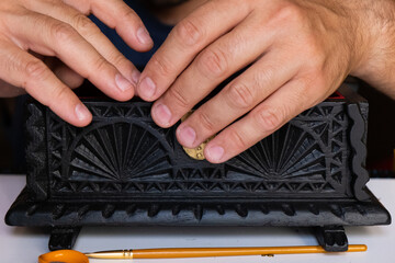 Close-up of a man fixing a wooden box. Concept carpentry at home, furniture restoration