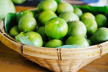 Limes in woven basket at a farmers market