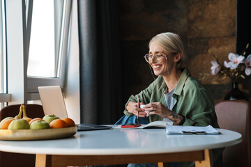 Middle aged blonde woman with short hair studying